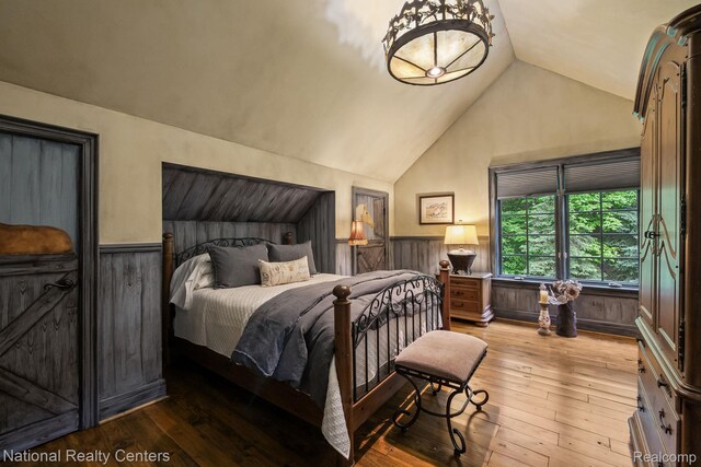 6654 College Park, Clarkston, MI 48346 - bedroom with a wainscoted wall, lofted ceiling, hardwood / wood-style floors, and wooden walls