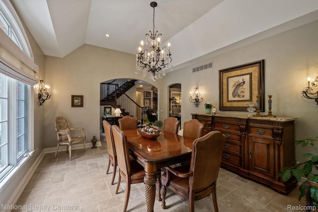 6654 College Park, Clarkston, MI 48346 - dining room with arched walkways, a chandelier, stone tile flooring, healthy amount of natural light, and vaulted ceiling