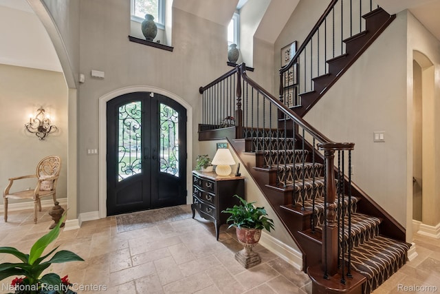 6654 College Park, Clarkston, MI 48346 - entrance foyer with arched walkways, stone tile flooring, french doors, plenty of natural light, and a high ceiling