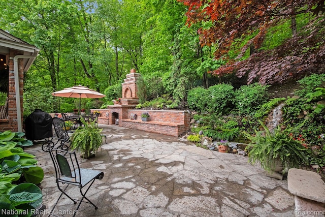 6654 College Park, Clarkston, MI 48346 - view of patio with an outdoor brick fireplace and grilling area