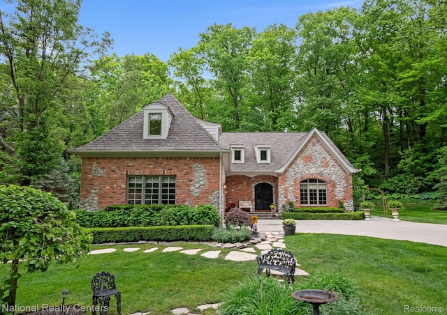 6654 College Park, Clarkston, MI 48346 - view of front of house featuring brick siding, a front yard, and a shingled roof