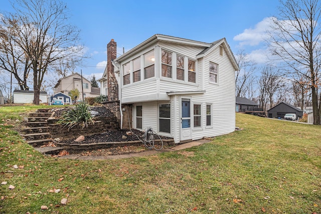 432 Market St, Walled Lake, MI 48390 - rear view of house with a chimney and a lawn