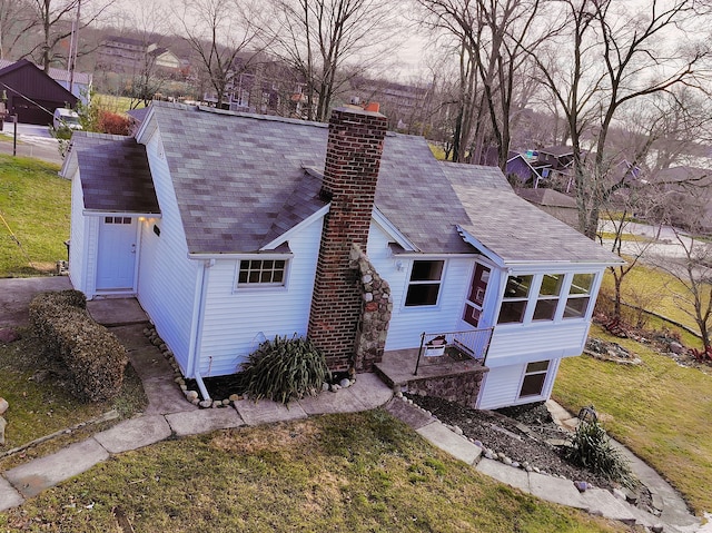 432 Market St, Walled Lake, MI 48390 - back of house featuring a chimney, a yard, and roof with shingles