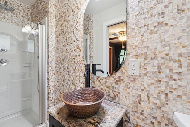 full bath featuring a shower and vanity