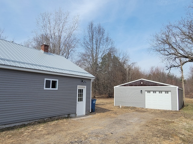 detached garage with dirt driveway