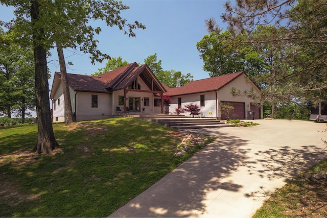 7107 Hallenbeck Hwy, Manitou Beach, MI 49253 - view of front facade with a front yard, an outdoor structure, concrete driveway, and an attached garage