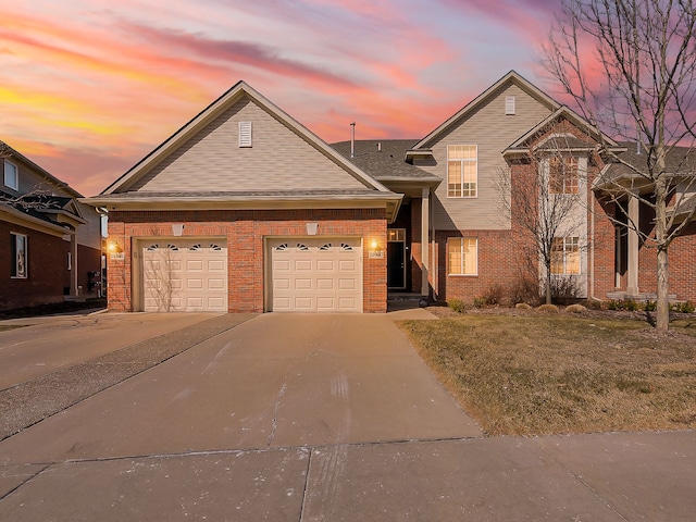 view of front of house with concrete driveway, brick siding, and a garage