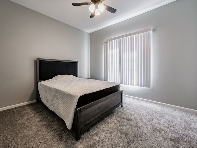 carpeted bedroom with a ceiling fan and baseboards