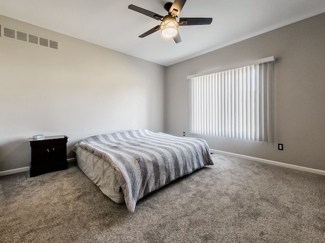 carpeted bedroom featuring visible vents, a ceiling fan, and baseboards