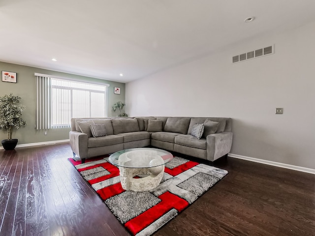 living room with visible vents, recessed lighting, baseboards, and wood finished floors