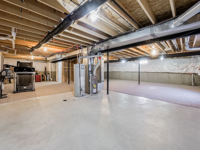 unfinished basement with gas water heater and heating unit