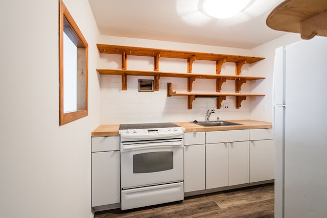 kitchen with white appliances, open shelves, wooden counters, and a sink