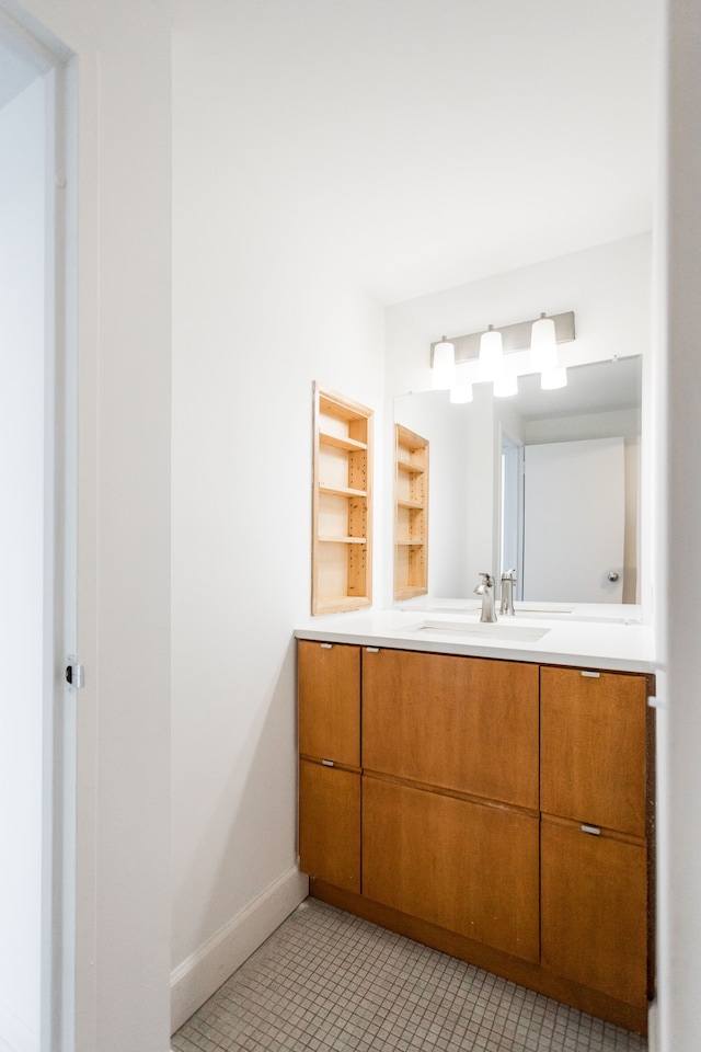 bathroom featuring vanity, tile patterned floors, and baseboards