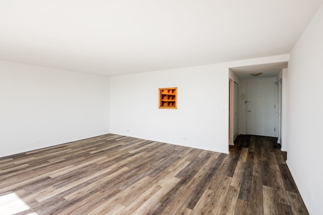 spare room featuring wood finished floors