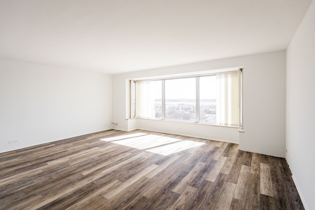 unfurnished room with wood finished floors