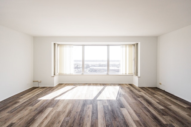 spare room featuring wood finished floors