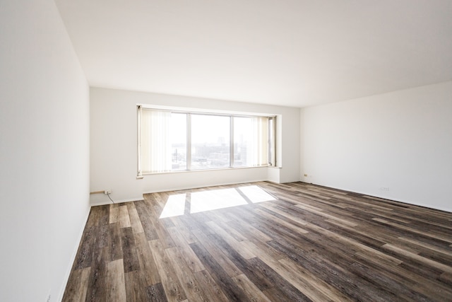 unfurnished room featuring dark wood-style floors