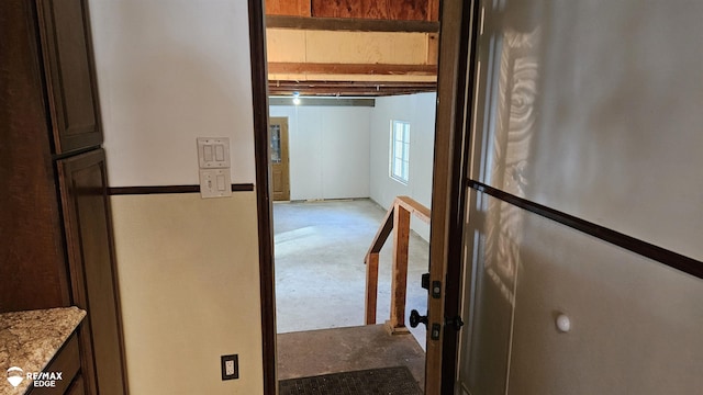 hall featuring unfinished concrete floors