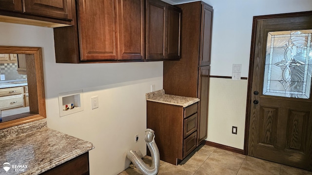 laundry area featuring cabinet space, light tile patterned floors, and hookup for a washing machine