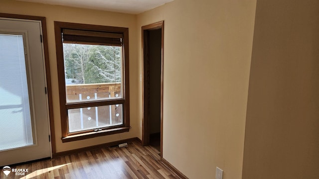 entryway with wood finished floors and baseboards