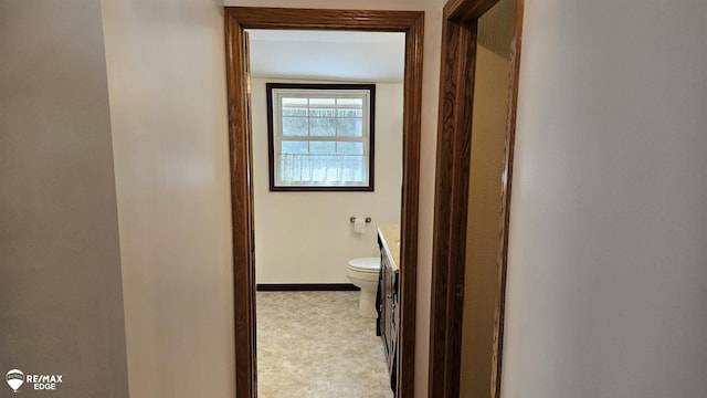 hall featuring baseboards