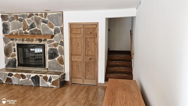detailed view of wood finished floors and a stone fireplace