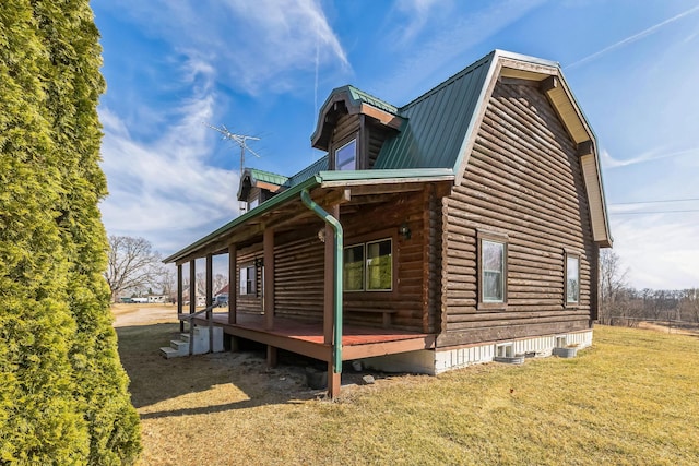 view of property exterior with metal roof, a gambrel roof, a lawn, and log exterior