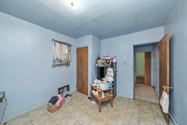 interior space featuring light tile patterned floors and baseboards
