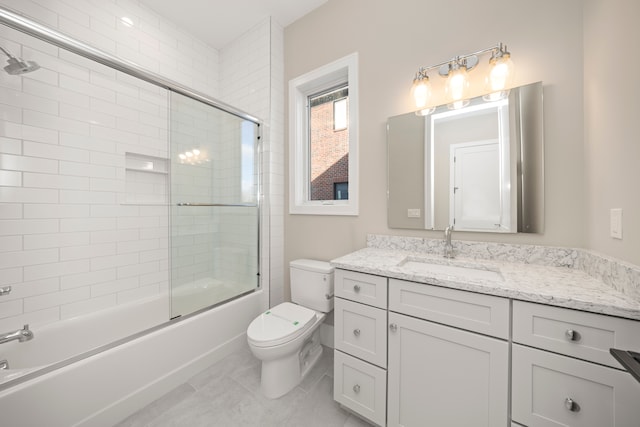 full bathroom with vanity, toilet, and bath / shower combo with glass door