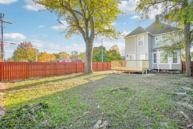 3736 Iroquois St, Detroit, MI 48214 - view of yard featuring a deck and a fenced backyard