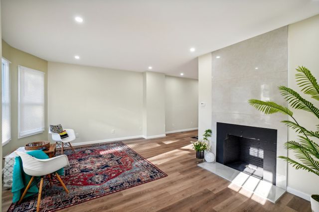3736 Iroquois St, Detroit, MI 48214 - living area featuring recessed lighting, baseboards, wood finished floors, and a fireplace
