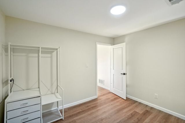 3736 Iroquois St, Detroit, MI 48214 - unfurnished bedroom featuring visible vents, wood finished floors, and baseboards