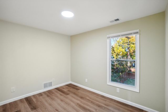 3736 Iroquois St, Detroit, MI 48214 - spare room with visible vents, baseboards, and wood finished floors