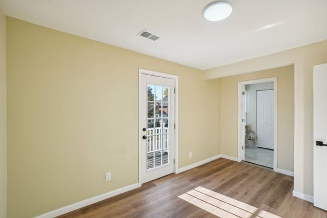 3736 Iroquois St, Detroit, MI 48214 - unfurnished room featuring visible vents, baseboards, and wood finished floors