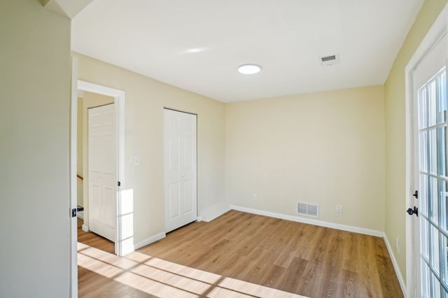 3736 Iroquois St, Detroit, MI 48214 - unfurnished room featuring visible vents, baseboards, and light wood-style floors
