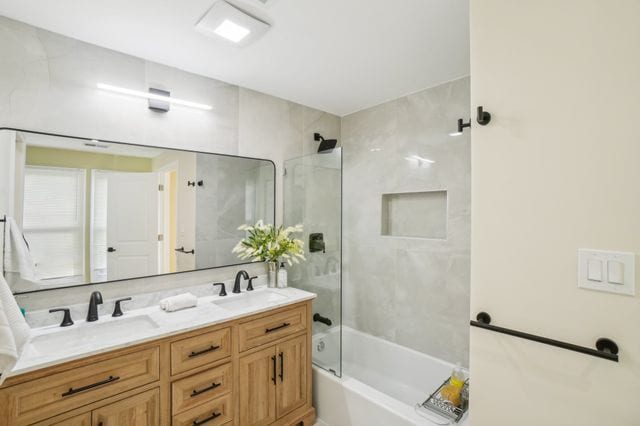 3736 Iroquois St, Detroit, MI 48214 - full bath with double vanity, washtub / shower combination, and a sink