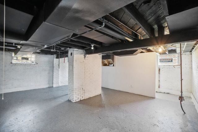 3736 Iroquois St, Detroit, MI 48214 - basement featuring brick wall
