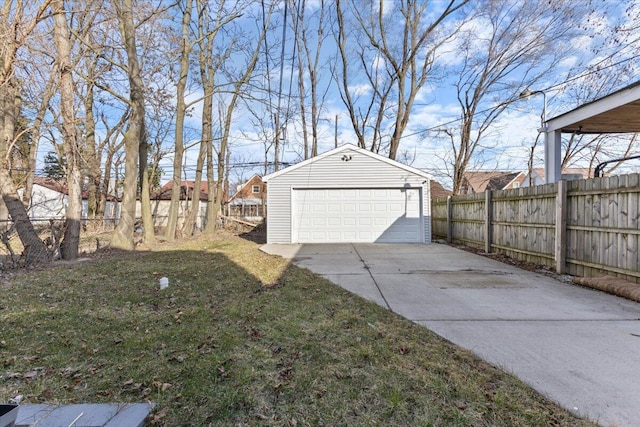 detached garage featuring fence