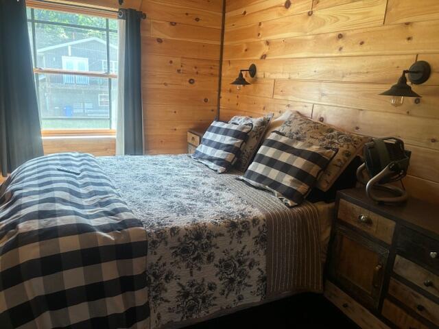bedroom with wooden walls