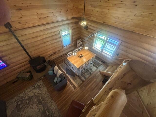 interior space with a wood stove and log walls