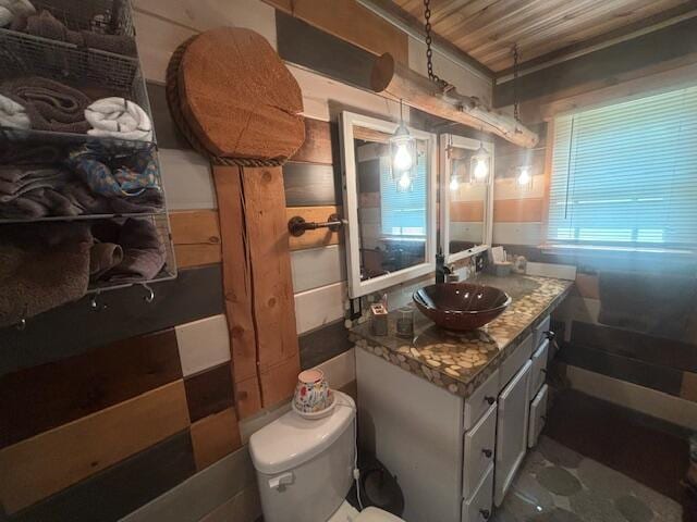 half bathroom with vanity and toilet