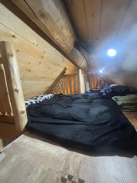 unfurnished bedroom with vaulted ceiling and wood ceiling