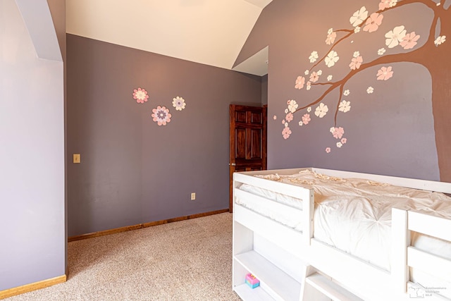 unfurnished bedroom featuring carpet floors, baseboards, and lofted ceiling