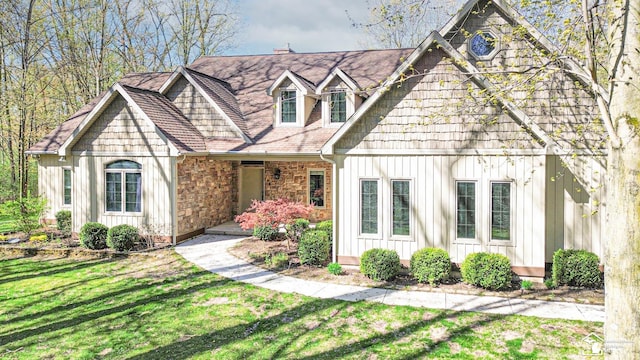view of front of house with a front lawn and board and batten siding