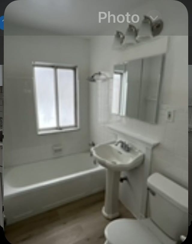 22131 Nevada Ave, Eastpointe, MI 48021 - full bathroom featuring toilet, shower / bath combination, and wood finished floors