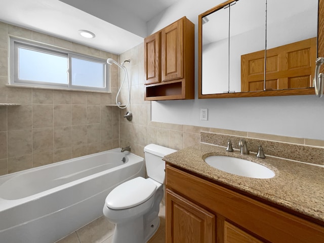 bathroom with toilet, tile walls, bathtub / shower combination, and vanity