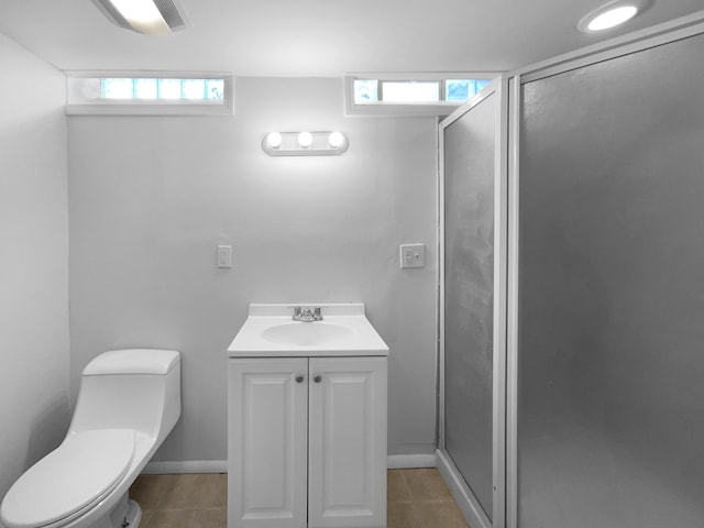 bathroom with tile patterned floors, a stall shower, a wealth of natural light, and toilet
