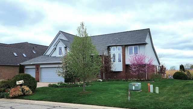 view of front of house featuring a front lawn, a shingled roof, brick siding, and a garage