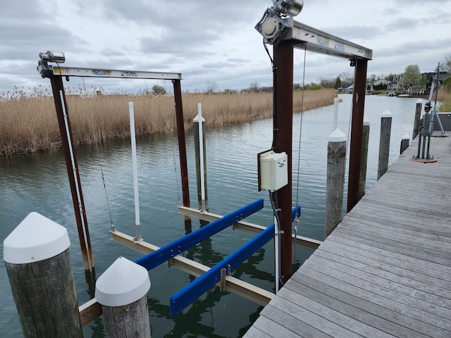 view of dock featuring boat lift and a water view