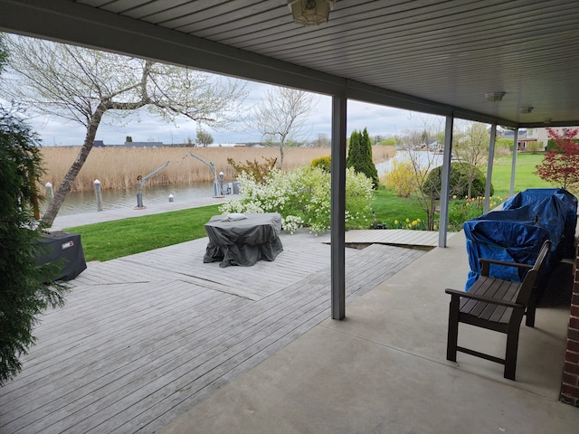view of patio / terrace with a deck with water view